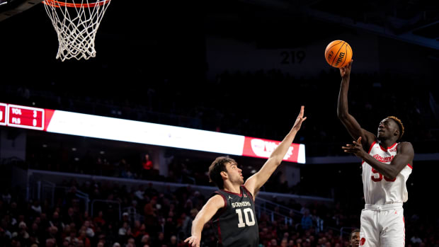 Cincinnati Bearcats forward Aziz Bandaogo (55) hits a basket over Oklahoma Sooners forward Sam Godwin (10) in the second half of the NCAA basketball game between Cincinnati Bearcats and Oklahoma Sooners at Fifth Third Arena in Cincinnati on Saturday, Jan. 20, 2024